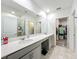 Bright bathroom features a double vanity, modern fixtures, and a glass-enclosed shower, plus a walk-in closet at 2861 Black Birch Dr, Ocoee, FL 34761