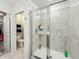 The bathroom features a spacious walk-in shower with a glass door and gray tiling at 2861 Black Birch Dr, Ocoee, FL 34761