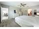 Bright bedroom with a ceiling fan, neutral walls, and an adjoining bathroom at 2861 Black Birch Dr, Ocoee, FL 34761