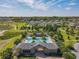 Aerial view of the community pool with lounge chairs, palm trees, and manicured landscaping at 2861 Black Birch Dr, Ocoee, FL 34761