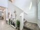 Inviting entryway features a staircase, decor, and a convenient coat rack with bench at 2861 Black Birch Dr, Ocoee, FL 34761