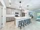 Modern kitchen with eat in island, stainless steel appliances, pendant lighting and tile flooring at 2861 Black Birch Dr, Ocoee, FL 34761