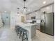 Modern kitchen island with seating, stainless steel appliances, subway tile backsplash and neutral color palette at 2861 Black Birch Dr, Ocoee, FL 34761
