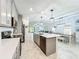 Modern kitchen with gray cabinets, stainless steel appliances, and a kitchen island at 2861 Black Birch Dr, Ocoee, FL 34761