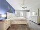 Spacious main bedroom with white furniture and a serene, painted accent wall at 2861 Black Birch Dr, Ocoee, FL 34761