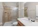 Neutral bathroom featuring tile shower with glass doors and wood cabinet with sink at 2898 Oakwater Dr # 2898, Kissimmee, FL 34747