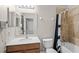 Bathroom featuring tan tile in shower, a vanity with a large mirror and vanity lighting at 2898 Oakwater Dr # 2898, Kissimmee, FL 34747