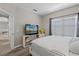 Cozy bedroom with window, light walls, and modern furnishings, including TV and decor at 2898 Oakwater Dr # 2898, Kissimmee, FL 34747