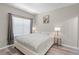 Bright bedroom features a large window, a queen bed, and minimalist decor at 2898 Oakwater Dr # 2898, Kissimmee, FL 34747