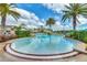 Inviting community pool featuring palm trees and plenty of seating at 2898 Oakwater Dr # 2898, Kissimmee, FL 34747
