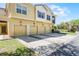 Well-maintained townhome complex featuring multiple garages, vibrant green lawns, and manicured landscaping at 2898 Oakwater Dr # 2898, Kissimmee, FL 34747