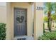 Charming front door, decorated with a wreath, and beautiful green landscaping at 2898 Oakwater Dr # 2898, Kissimmee, FL 34747