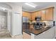 Modern kitchen featuring stainless steel appliances, granite countertops, and wood cabinets at 2898 Oakwater Dr # 2898, Kissimmee, FL 34747