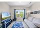 Inviting living room with large window, sofa, and modern entertainment center at 2898 Oakwater Dr # 2898, Kissimmee, FL 34747
