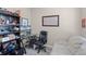 Office space with a desk, chair, shelving unit, and a comfortable, bright sitting area at 2898 Oakwater Dr # 2898, Kissimmee, FL 34747
