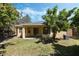 Backyard with a covered patio, trees, and grass at 2933 Star Grass Pt, Oviedo, FL 32766