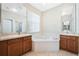 Bright bathroom featuring double sinks and a garden tub at 2933 Star Grass Pt, Oviedo, FL 32766