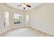 Bright bedroom with neutral carpet, ceiling fan, and natural light from three windows at 2933 Star Grass Pt, Oviedo, FL 32766