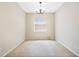Simple dining room with neutral walls, carpet, a chandelier, and a window at 2933 Star Grass Pt, Oviedo, FL 32766