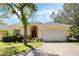 Charming single-story home with a well-manicured lawn, brick driveway and an attached two-car garage at 2933 Star Grass Pt, Oviedo, FL 32766