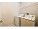 Bright laundry room featuring a washing machine, dryer, and wire shelving at 2933 Star Grass Pt, Oviedo, FL 32766