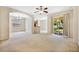 Spacious living room with neutral carpet, large sliding glass doors, and adjacent dining area at 2933 Star Grass Pt, Oviedo, FL 32766