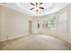 Spacious main bedroom featuring carpet, trey ceiling, ceiling fan, and plenty of windows at 2933 Star Grass Pt, Oviedo, FL 32766