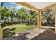 Covered patio overlooking the fenced backyard and trees at 2933 Star Grass Pt, Oviedo, FL 32766