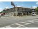 Elegant two-story building with ornamental iron balconies and a prominent street corner location at 33332 Seattle Slew Dr, Sorrento, FL 32776