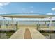 Picturesque waterfront gazebo, offering comfortable seating and panoramic views of the tranquil water at 33332 Seattle Slew Dr, Sorrento, FL 32776