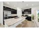 Modern kitchen featuring dark cabinets, stainless steel appliances, granite countertops, and a large island at 33332 Seattle Slew Dr, Sorrento, FL 32776