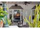 Outdoor seating area under a covered patio with a ceiling fan at 33332 Seattle Slew Dr, Sorrento, FL 32776