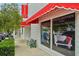 Museum of Modernism storefront featuring a window display of Space Oddities memorabilia and a bench at 33332 Seattle Slew Dr, Sorrento, FL 32776