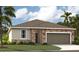 Charming single-story home with a stone-accented facade, two-car garage, and well-manicured lawn at 33336 Seattle Slew Dr, Sorrento, FL 32776