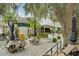 Inviting courtyard with outdoor seating, mature trees, plants, and stone accents; a peaceful outdoor retreat at 33436 Seattle Slew Dr, Sorrento, FL 32776