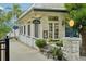 Charming shop front with textured facade, lamppost, well-manicured landscaping, and inviting bench at 33436 Seattle Slew Dr, Sorrento, FL 32776