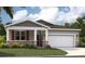 Charming single-Gathering home with stone accents, a two-car garage, and well-maintained landscaping at 33436 Seattle Slew Dr, Sorrento, FL 32776