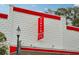Unique building design with a textured facade, red awnings, and decorative banner at 33436 Seattle Slew Dr, Sorrento, FL 32776