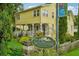 Charming yellow Gatehouse with a decorative sign and well-manicured landscaping at 33436 Seattle Slew Dr, Sorrento, FL 32776