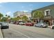 Street view of charming buildings with palm trees lining the street, showcasing a quaint commercial district at 33436 Seattle Slew Dr, Sorrento, FL 32776