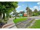 Scenic street view with visible railroad tracks, lake view, and colorful buildings in the background at 33436 Seattle Slew Dr, Sorrento, FL 32776