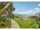 Serene waterfront view with lush greenery, dock access, and a charming boat house for tranquil living at 33436 Seattle Slew Dr, Sorrento, FL 32776