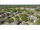 Aerial view of the home nestled among mature trees in a peaceful residential neighborhood at 3344 Quailwest Ct, Orlando, FL 32812