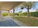 View of the backyard with a covered patio and a patterned outdoor rug at 3344 Quailwest Ct, Orlando, FL 32812