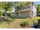 Spacious backyard featuring a two-story house with a balcony and covered patio at 3344 Quailwest Ct, Orlando, FL 32812