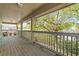 Relaxing covered balcony with chairs overlooking lush greenery and a beautiful view at 3344 Quailwest Ct, Orlando, FL 32812