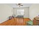 Bright bedroom features hardwood floors, ceiling fan, and a window allowing for plenty of natural light at 3344 Quailwest Ct, Orlando, FL 32812