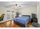 Bright bedroom featuring a ceiling fan, outdoor access, and modern furniture at 3344 Quailwest Ct, Orlando, FL 32812