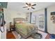 Cozy bedroom with hardwood floors, ceiling fan, and outdoor access at 3344 Quailwest Ct, Orlando, FL 32812