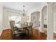 Elegant dining room with wood floors, modern chandelier, and large window for natural light at 3344 Quailwest Ct, Orlando, FL 32812